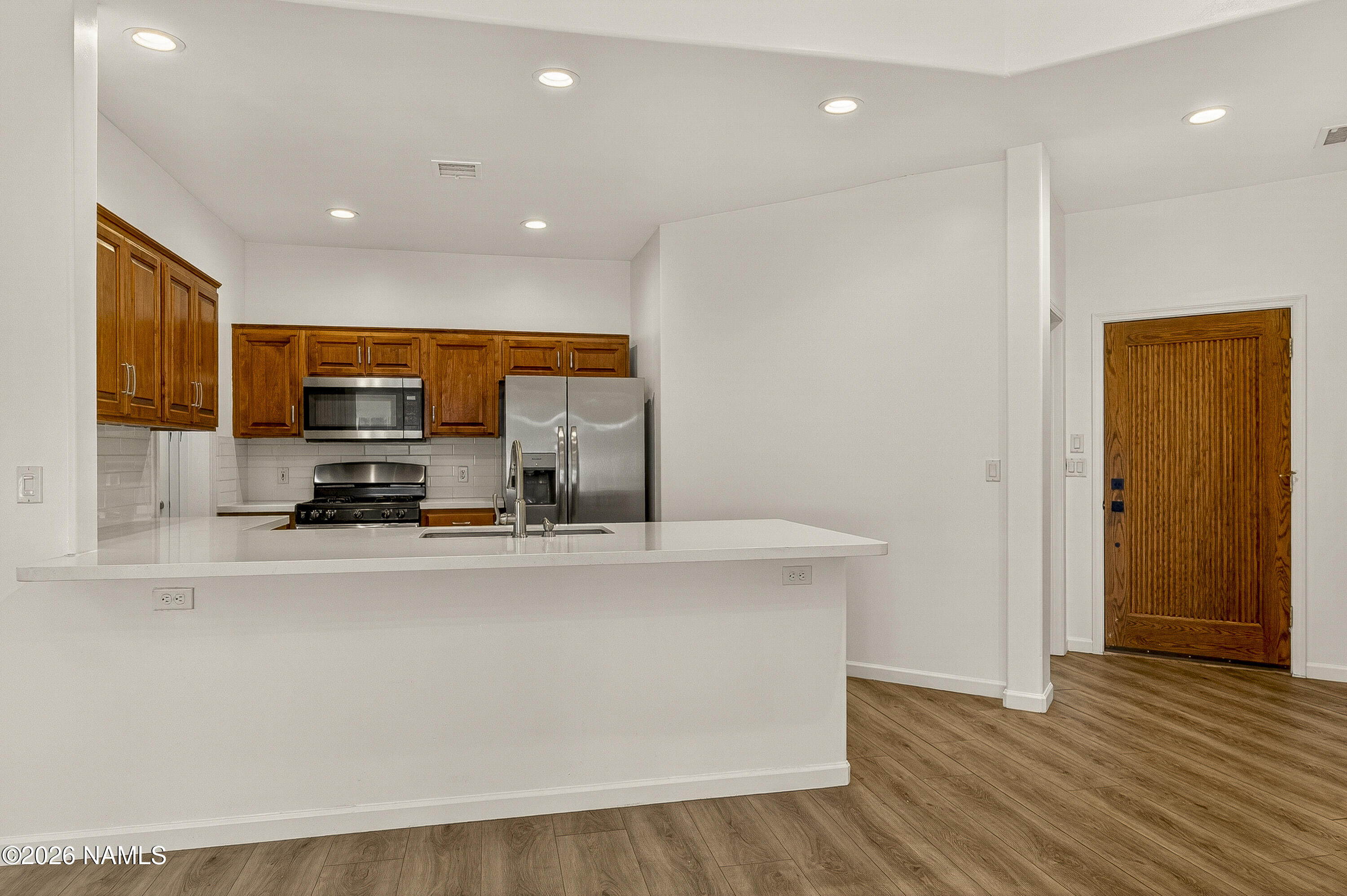 600 Brookline Loop Williams, AZ 86046 - Photo 12 of 43 a view of a kitchen with stainless steel appliances a sink and a stove top oven