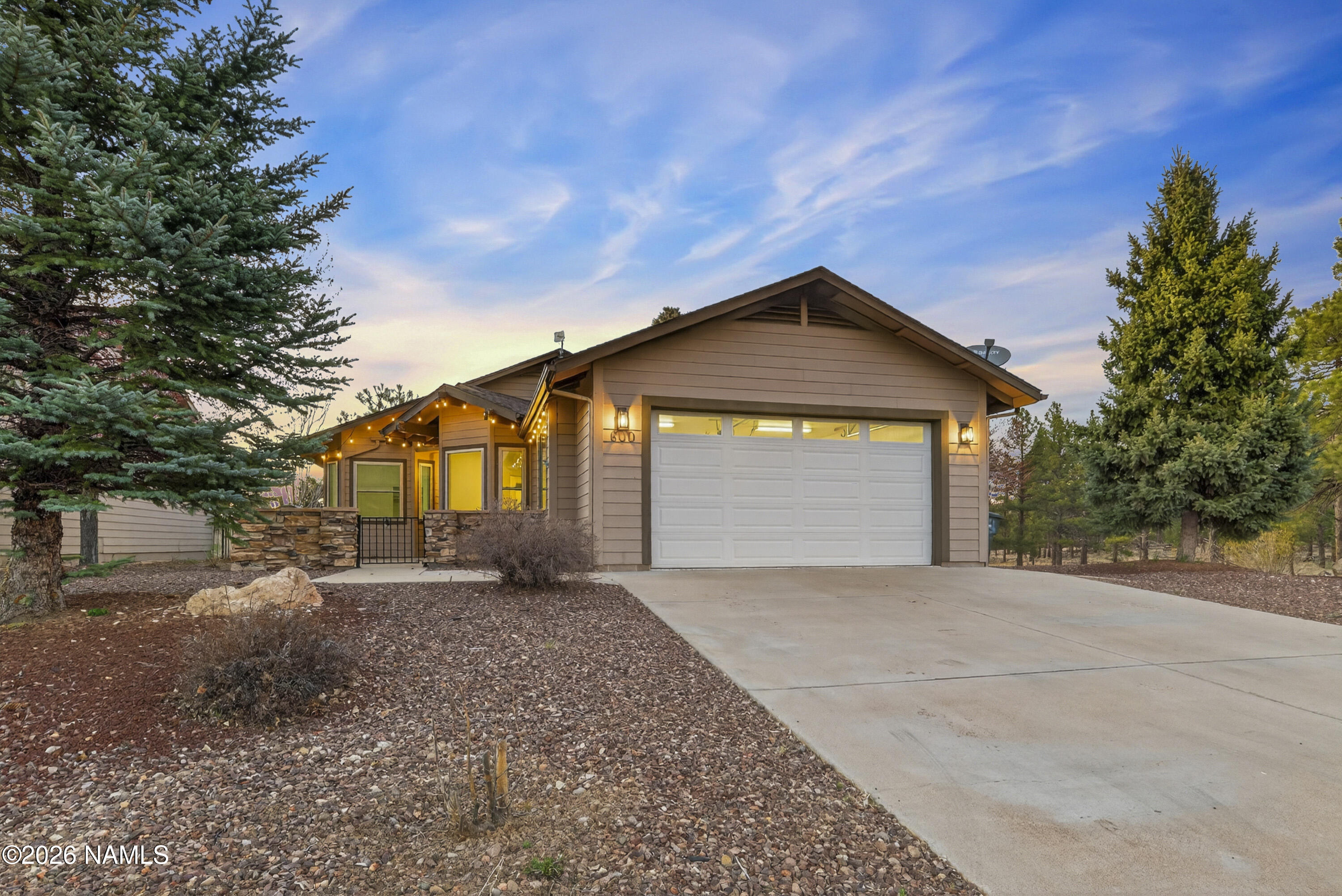 600 Brookline Loop Williams, AZ 86046 - Photo 2 of 43 a front view of a house with a yard and garage