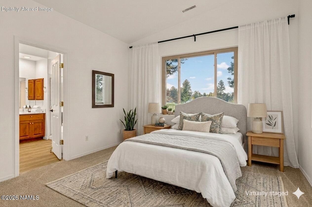 600 Brookline Loop Williams, AZ 86046 - Photo 23 of 43 a bedroom with a large bed and a window
