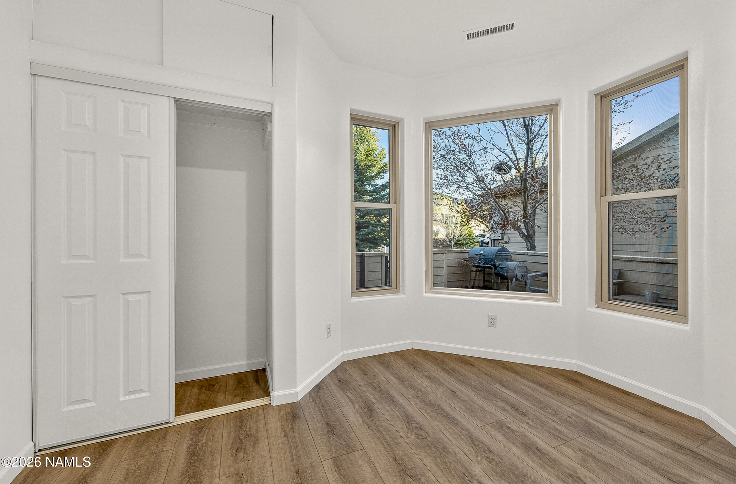 600 Brookline Loop Williams, AZ 86046 - Photo 29 of 43 an empty room with wooden floor and windows