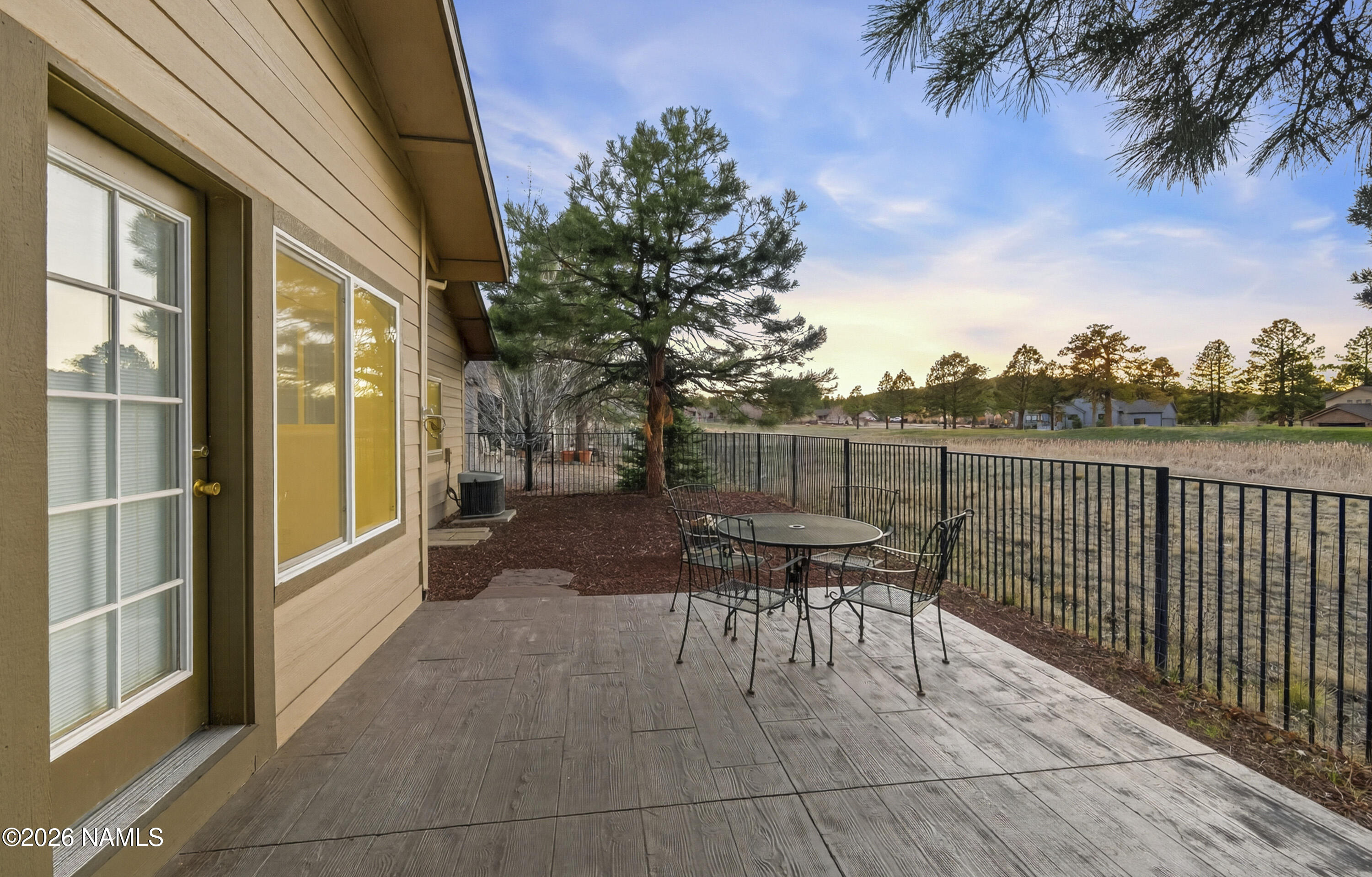 600 Brookline Loop Williams, AZ 86046 - Photo 10 of 43 a view of a patio with a table and chairs and potted plants