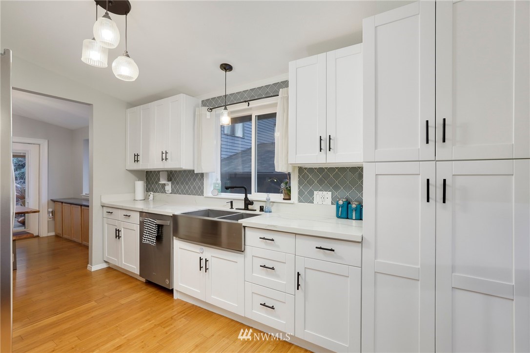 1701 174th Place Southeast Bothell, WA 98012 - Photo 11 of 40 a kitchen with white cabinets and white appliances
