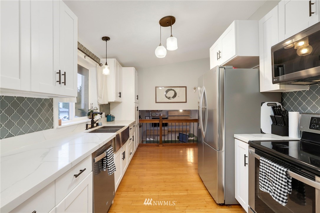 1701 174th Place Southeast Bothell, WA 98012 - Photo 12 of 40 a kitchen with stainless steel appliances a sink dishwasher stove and refrigerator