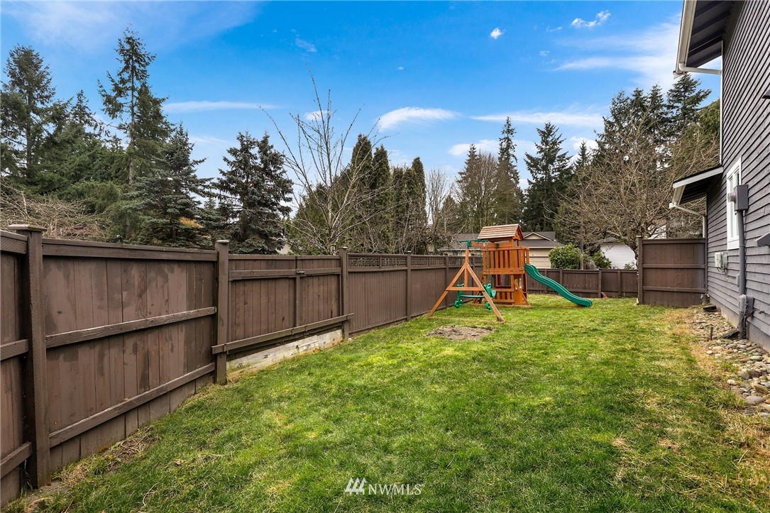 1701 174th Place Southeast Bothell, WA 98012 - Photo 36 of 40 a view of a backyard with a garden and fire pit