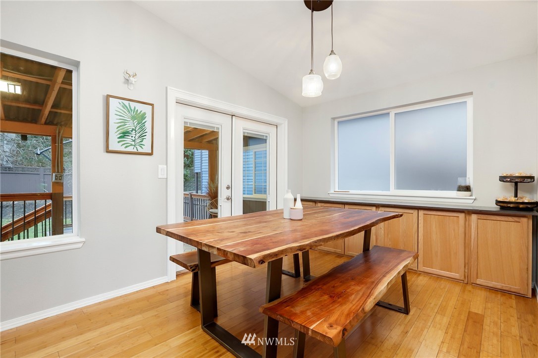 1701 174th Place Southeast Bothell, WA 98012 - Photo 8 of 40 a dining room with wooden floor and large windows