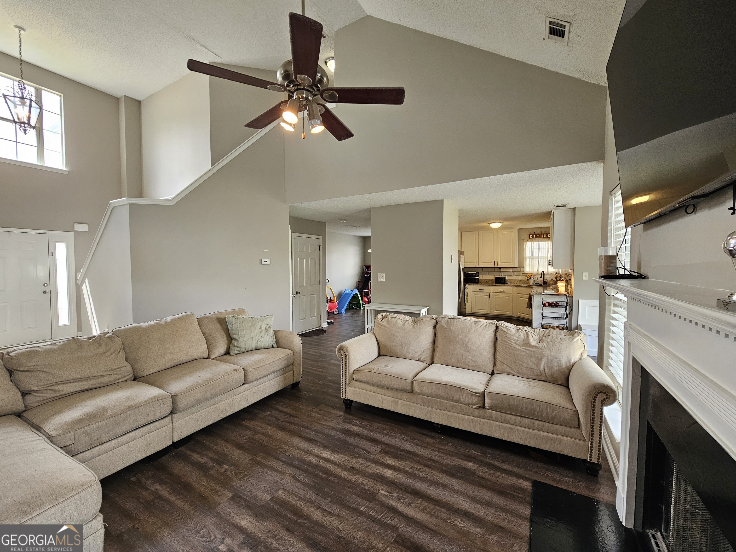 5077 Meadow Trace Fairburn, GA 30213 - Photo 21 of 43 a living room with furniture and a fireplace