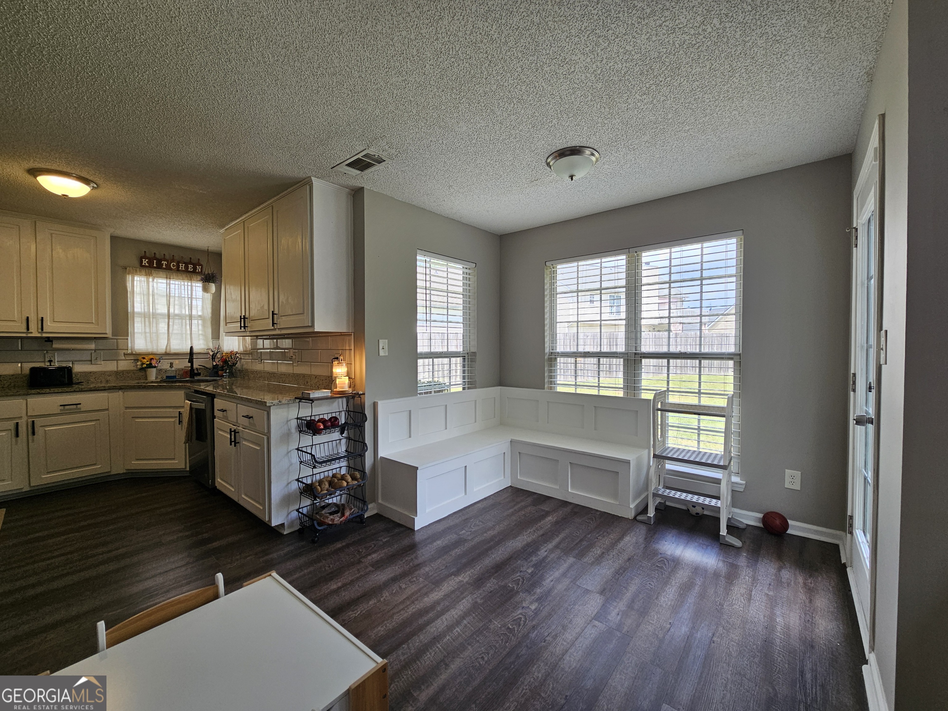 5077 Meadow Trace Fairburn, GA 30213 - Photo 23 of 43 a kitchen with a refrigerator wooden floor and a sink