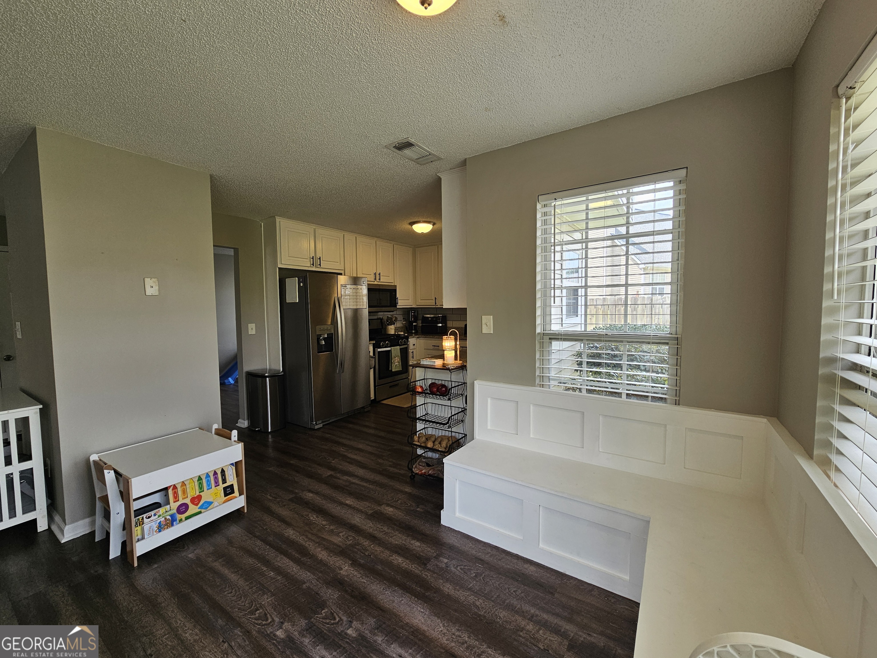 5077 Meadow Trace Fairburn, GA 30213 - Photo 24 of 43 a living room with furniture and a flat screen tv