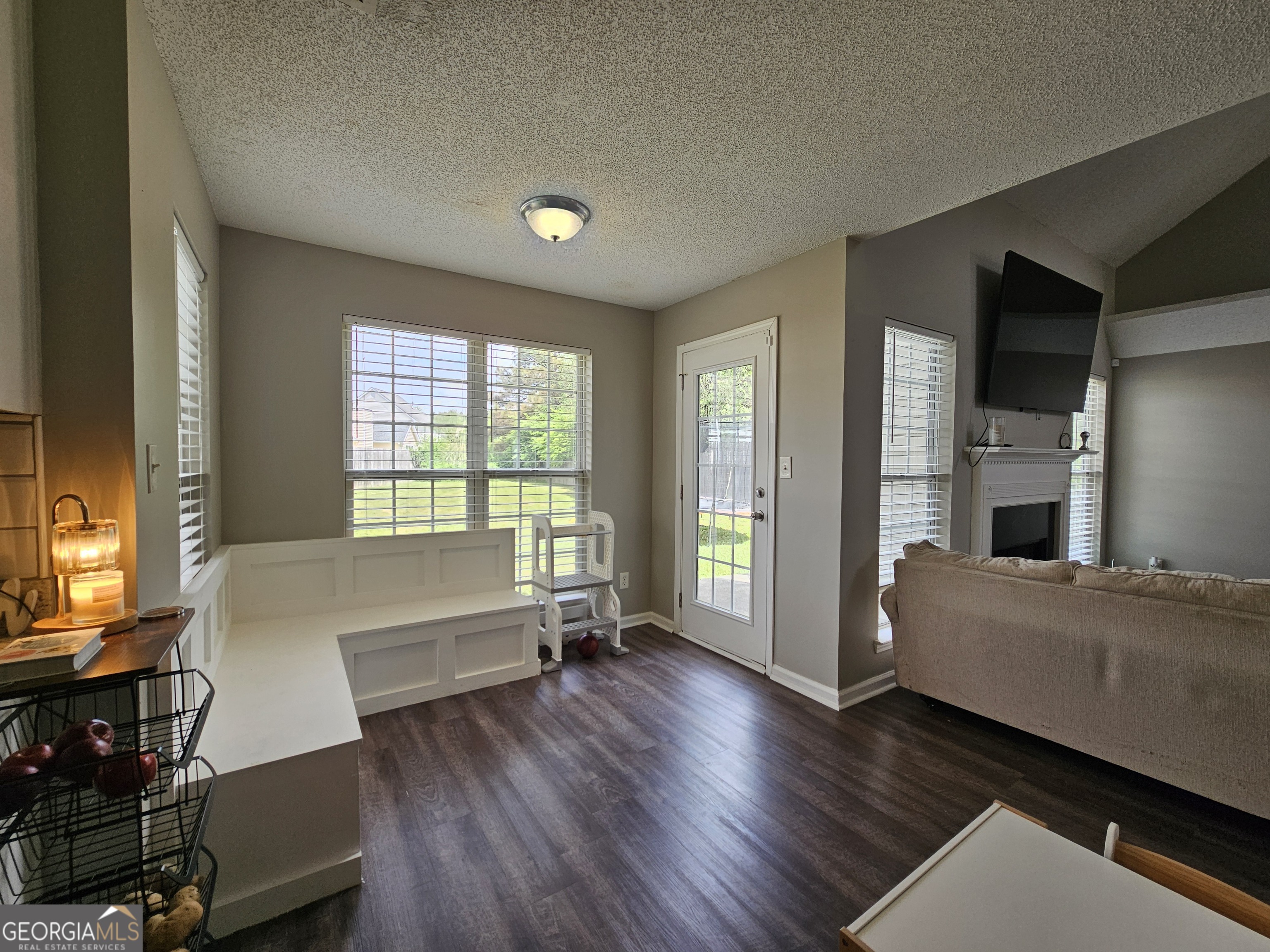 5077 Meadow Trace Fairburn, GA 30213 - Photo 25 of 43 a living room with a bed furniture and a large window