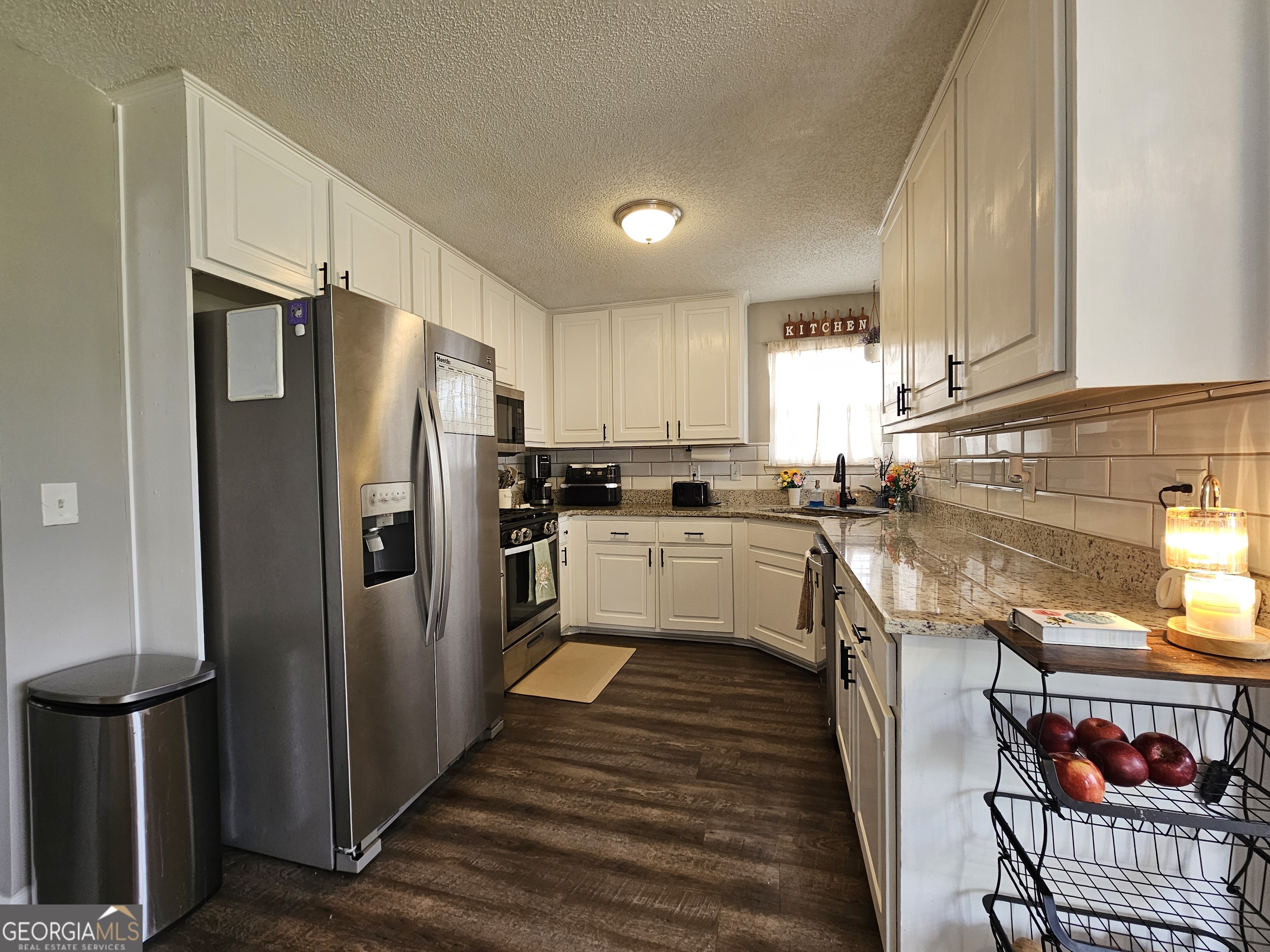 5077 Meadow Trace Fairburn, GA 30213 - Photo 27 of 43 a kitchen with stainless steel appliances a refrigerator sink and cabinets