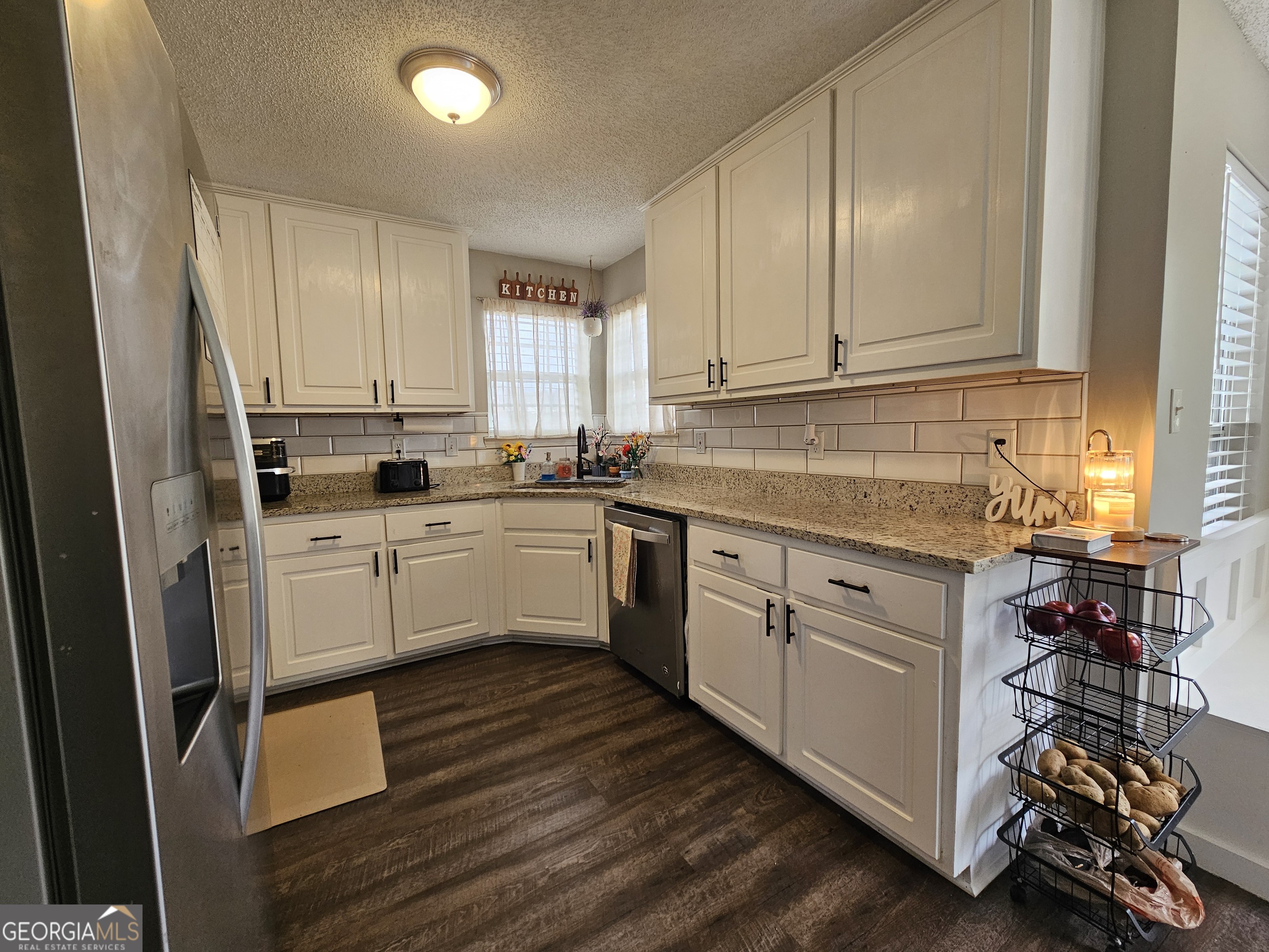 5077 Meadow Trace Fairburn, GA 30213 - Photo 28 of 43 a kitchen with white cabinets sink and white appliances