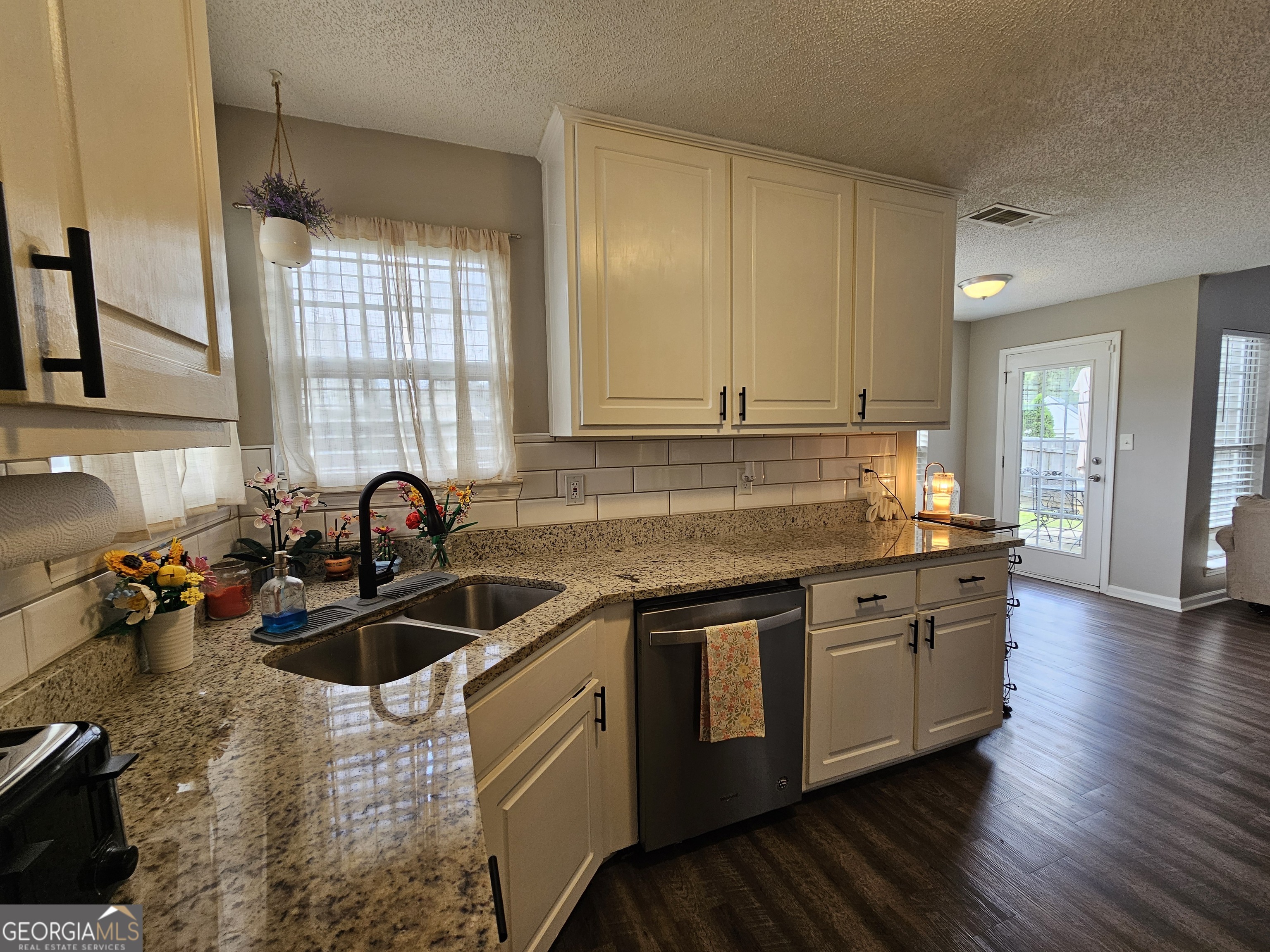 5077 Meadow Trace Fairburn, GA 30213 - Photo 31 of 43 a kitchen with stainless steel appliances granite countertop a sink stove and cabinets