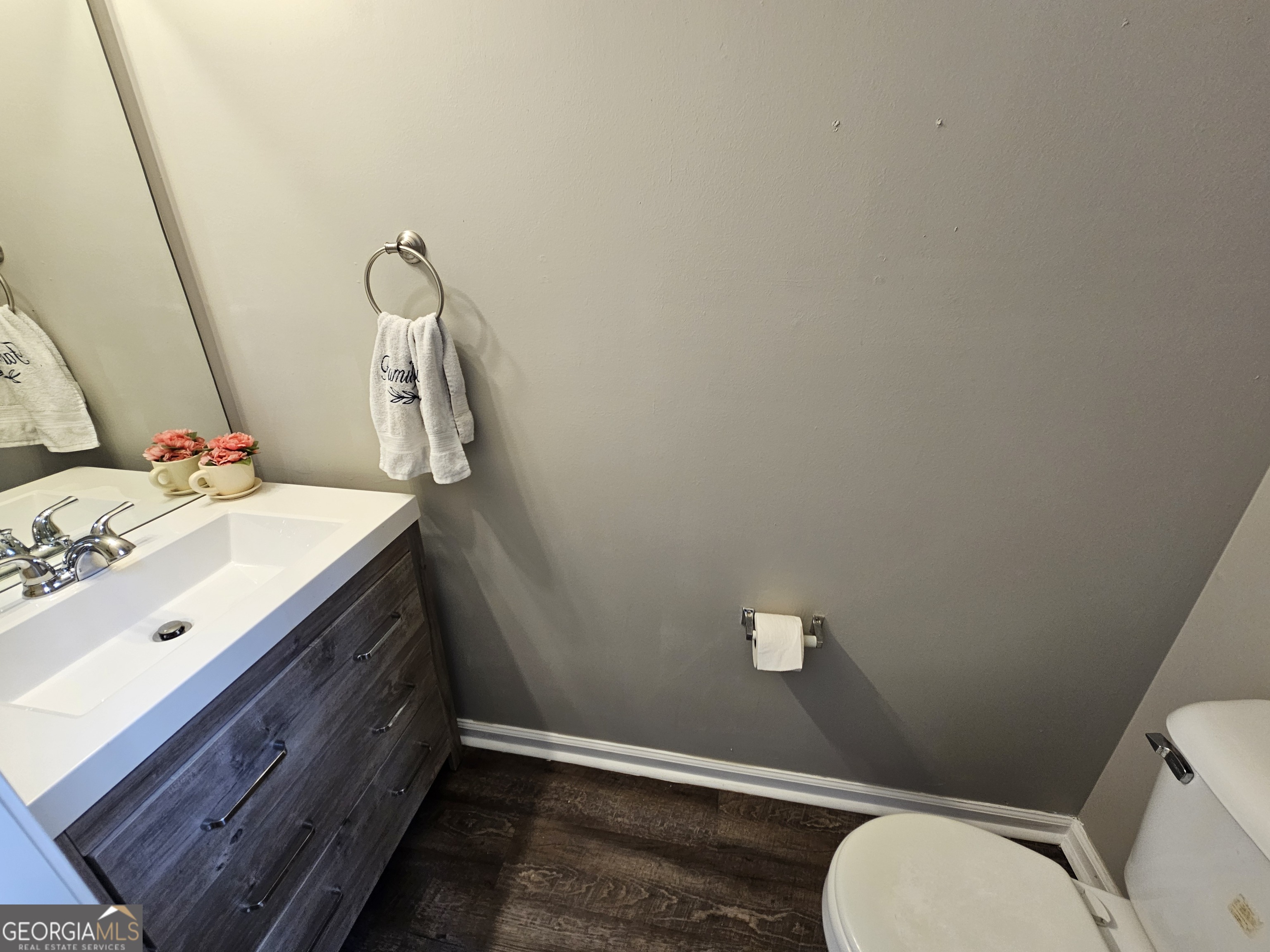 5077 Meadow Trace Fairburn, GA 30213 - Photo 33 of 43 a bathroom with a sink mirror vanity and toilet