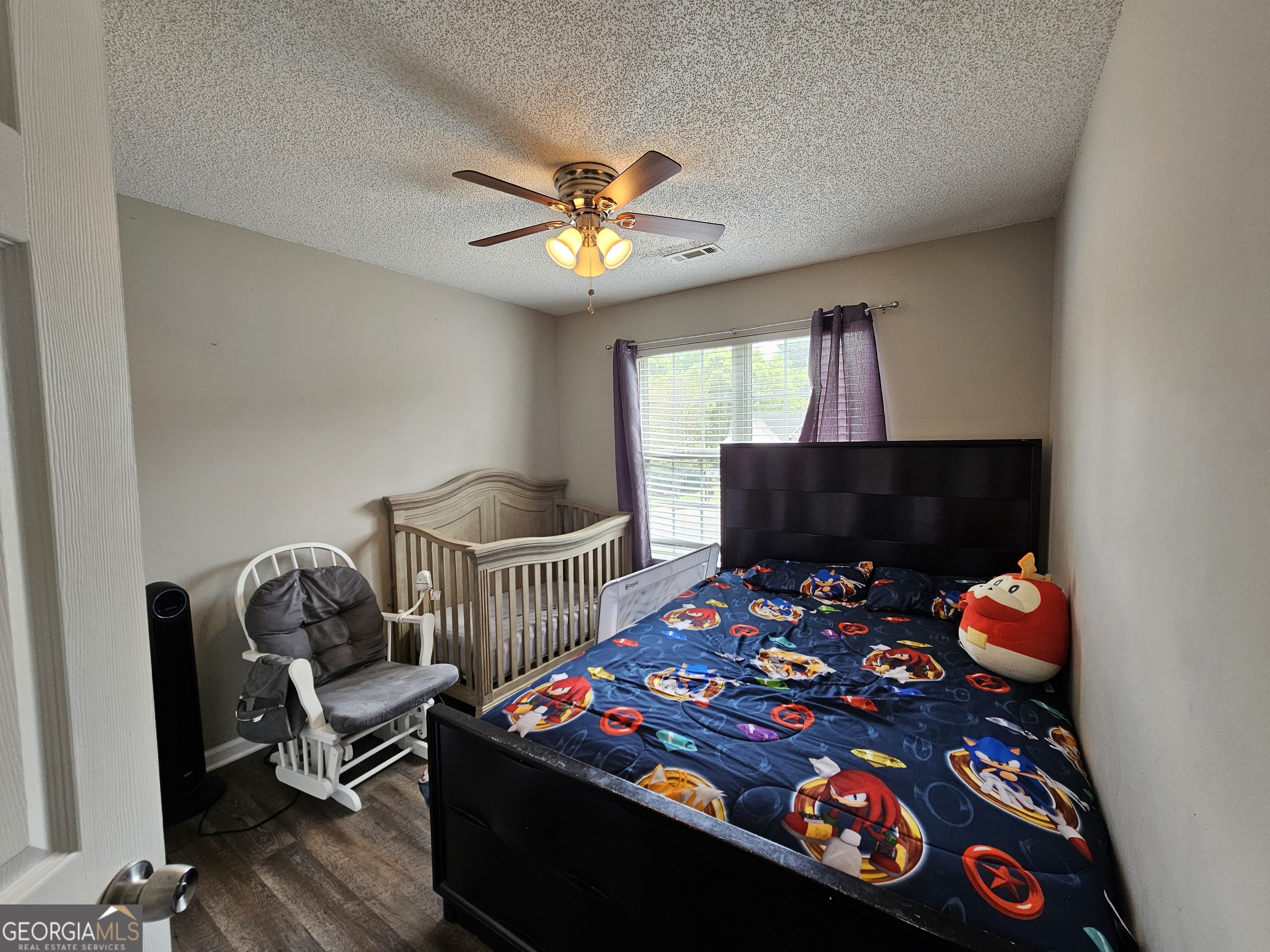 5077 Meadow Trace Fairburn, GA 30213 - Photo 35 of 43 a bedroom with a bed a couch and a chandelier