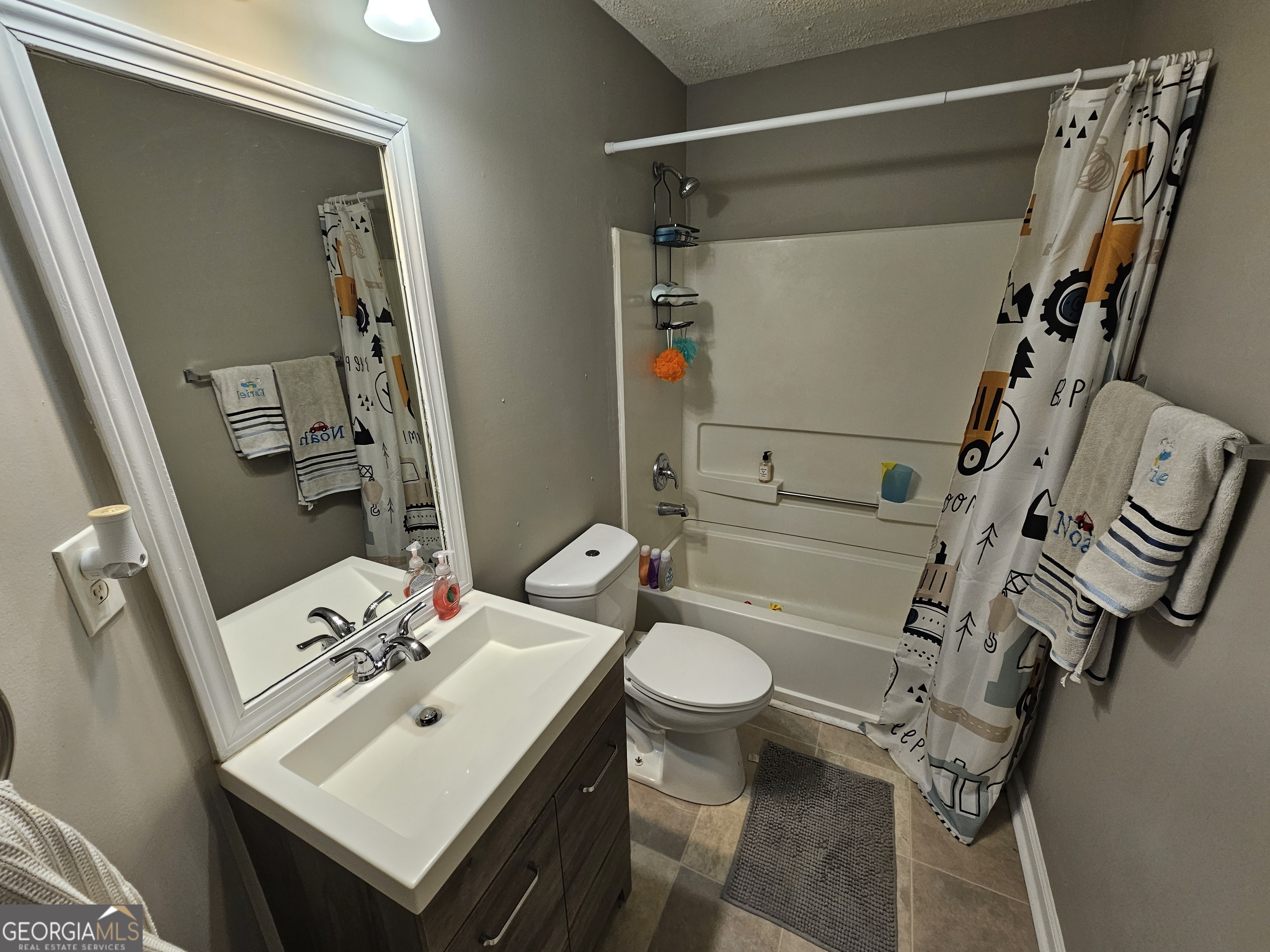 5077 Meadow Trace Fairburn, GA 30213 - Photo 36 of 43 a bathroom with a sink toilet and shower