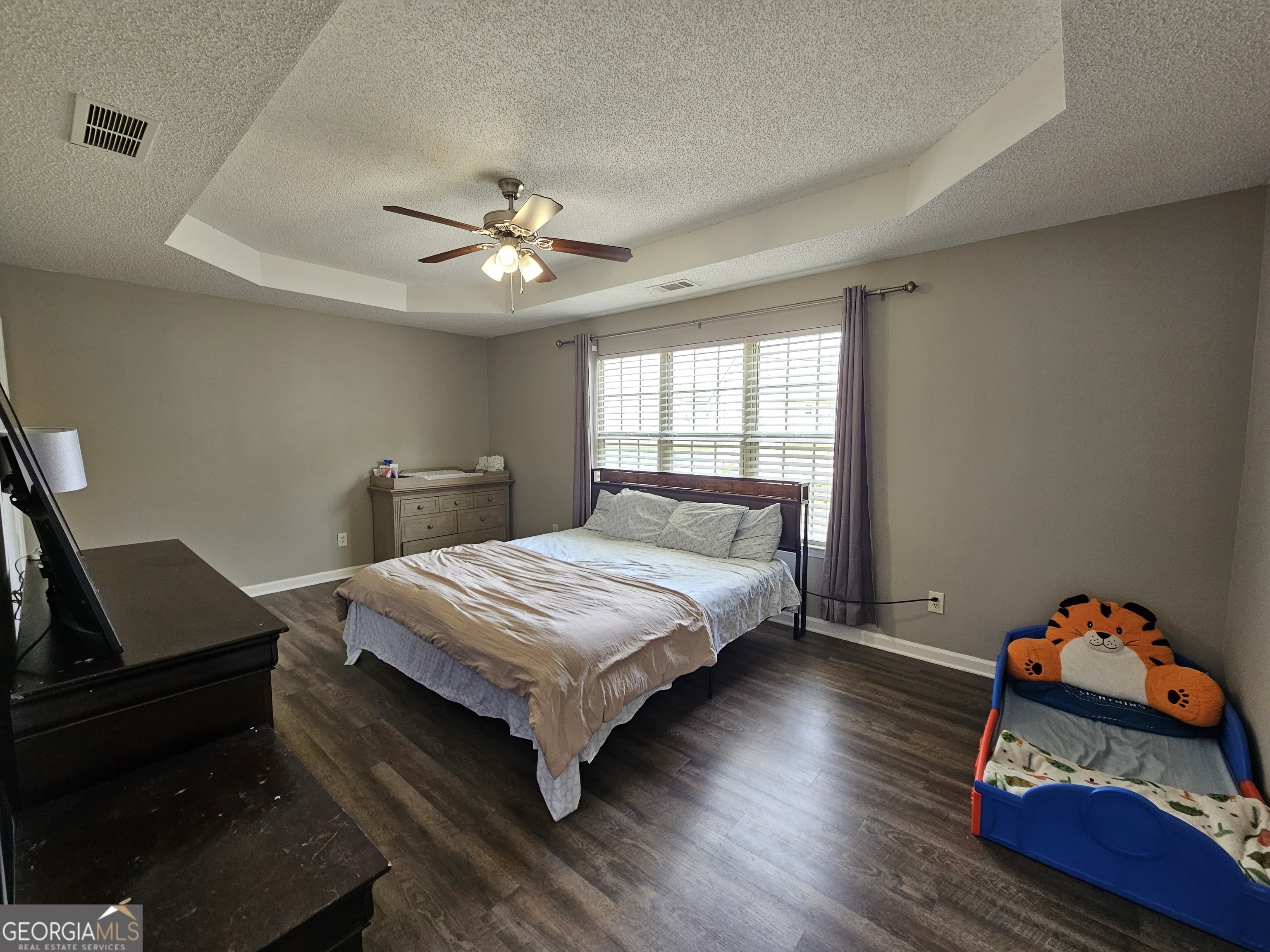 5077 Meadow Trace Fairburn, GA 30213 - Photo 37 of 43 a bedroom with a bed and wooden floor