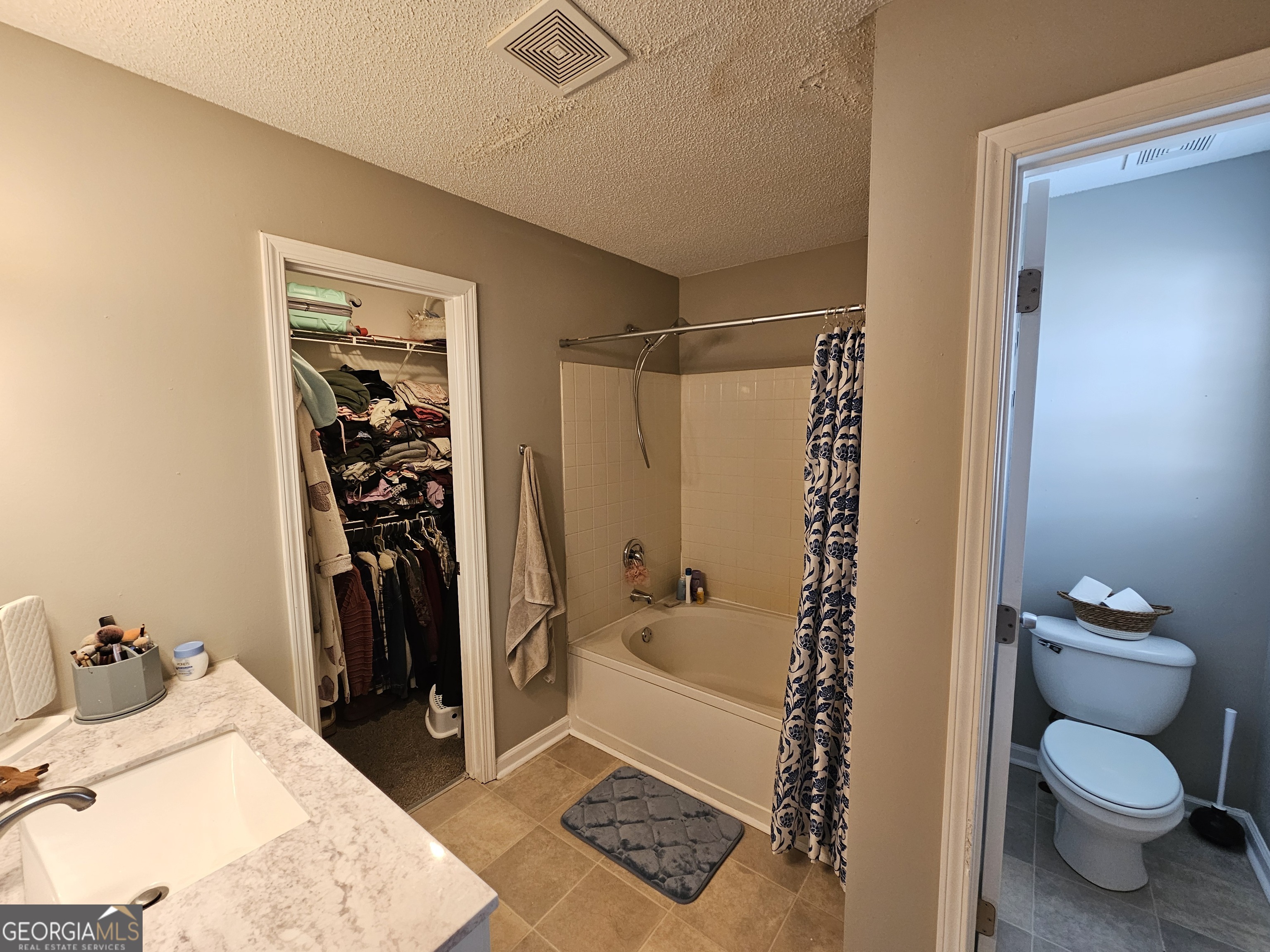 5077 Meadow Trace Fairburn, GA 30213 - Photo 40 of 43 a bathroom with a toilet and a shower