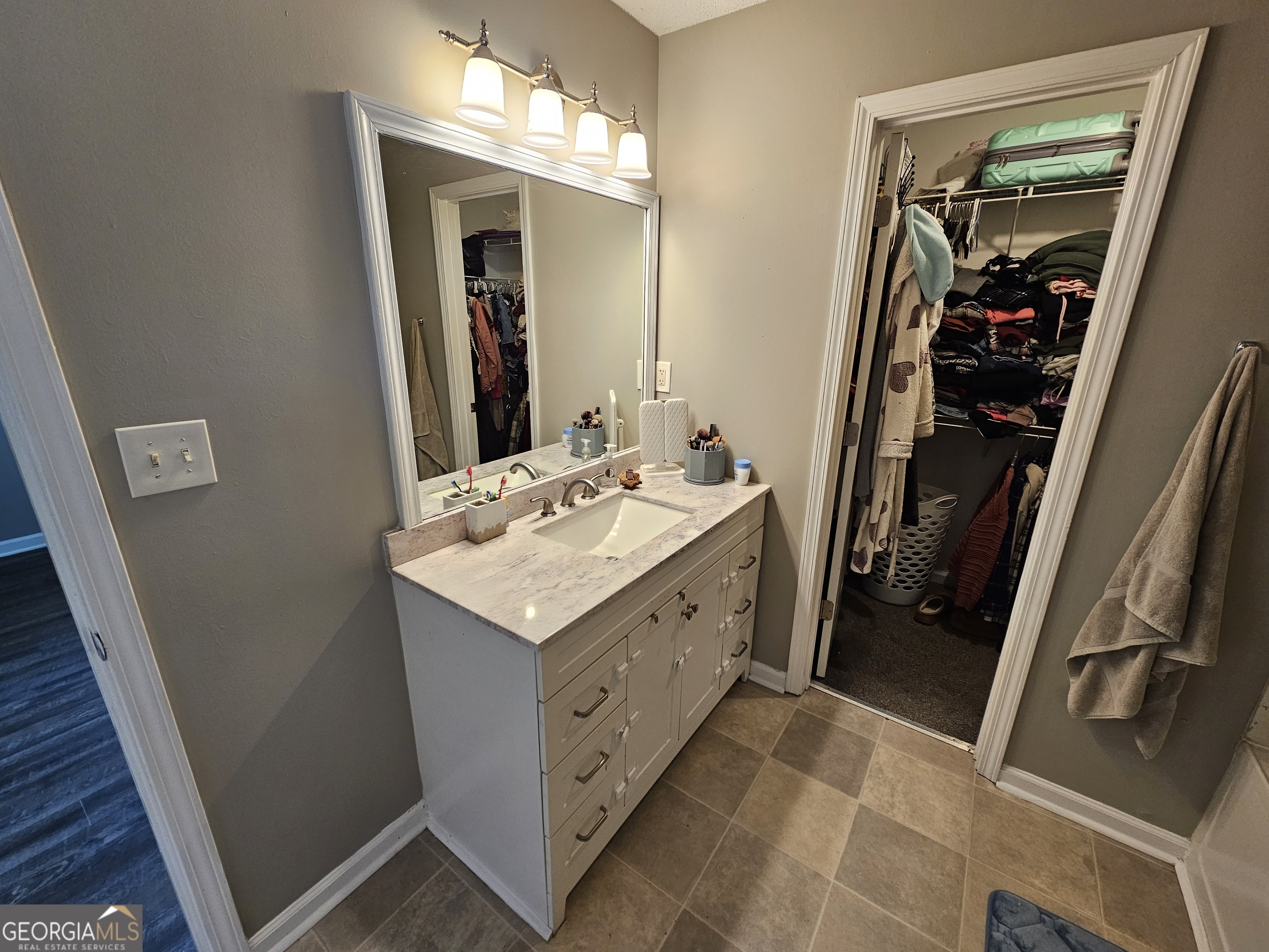 5077 Meadow Trace Fairburn, GA 30213 - Photo 42 of 43 a bathroom with a double vanity sink and mirror