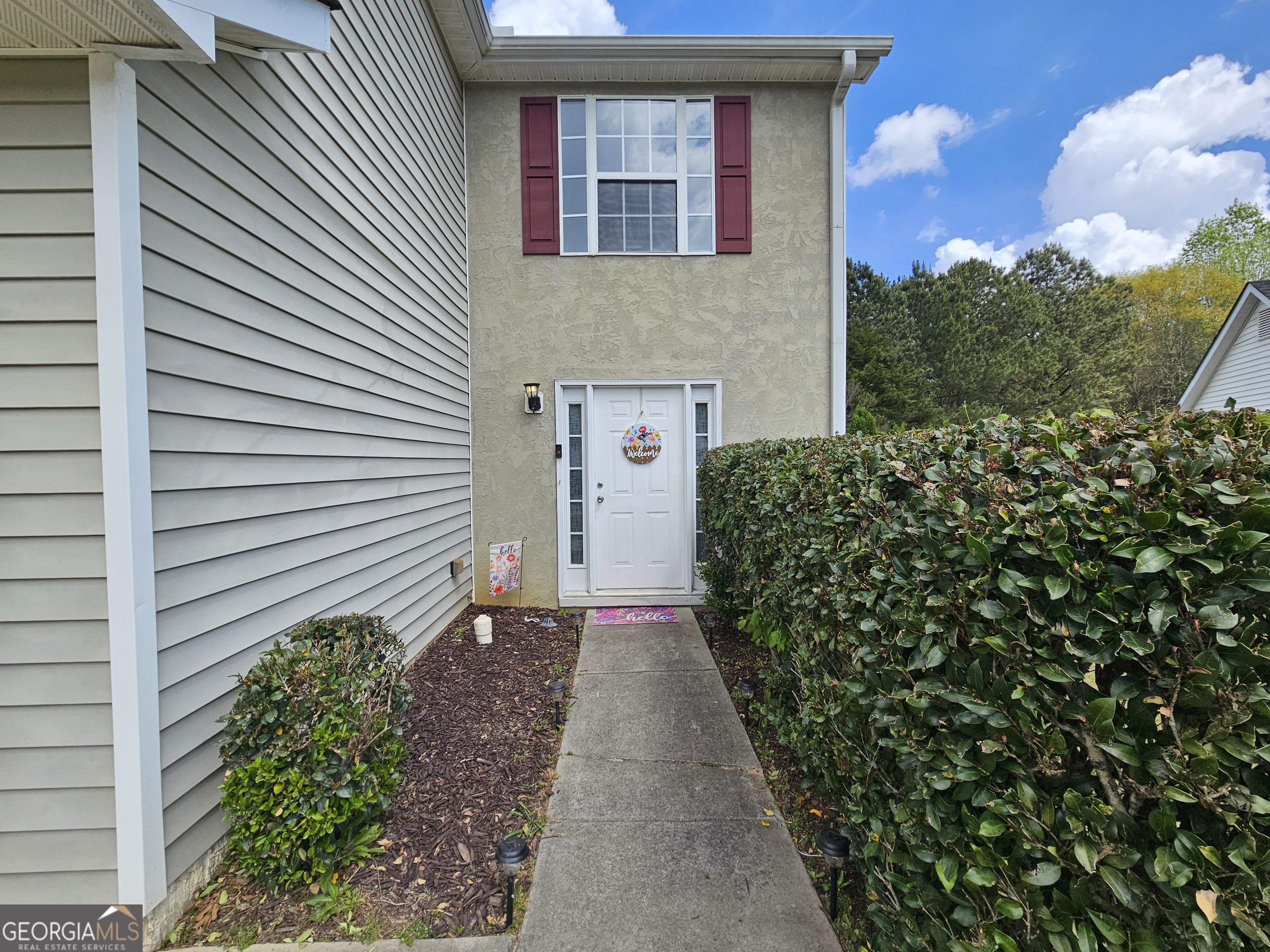 5077 Meadow Trace Fairburn, GA 30213 - Photo 5 of 43 a front view of a house with garden