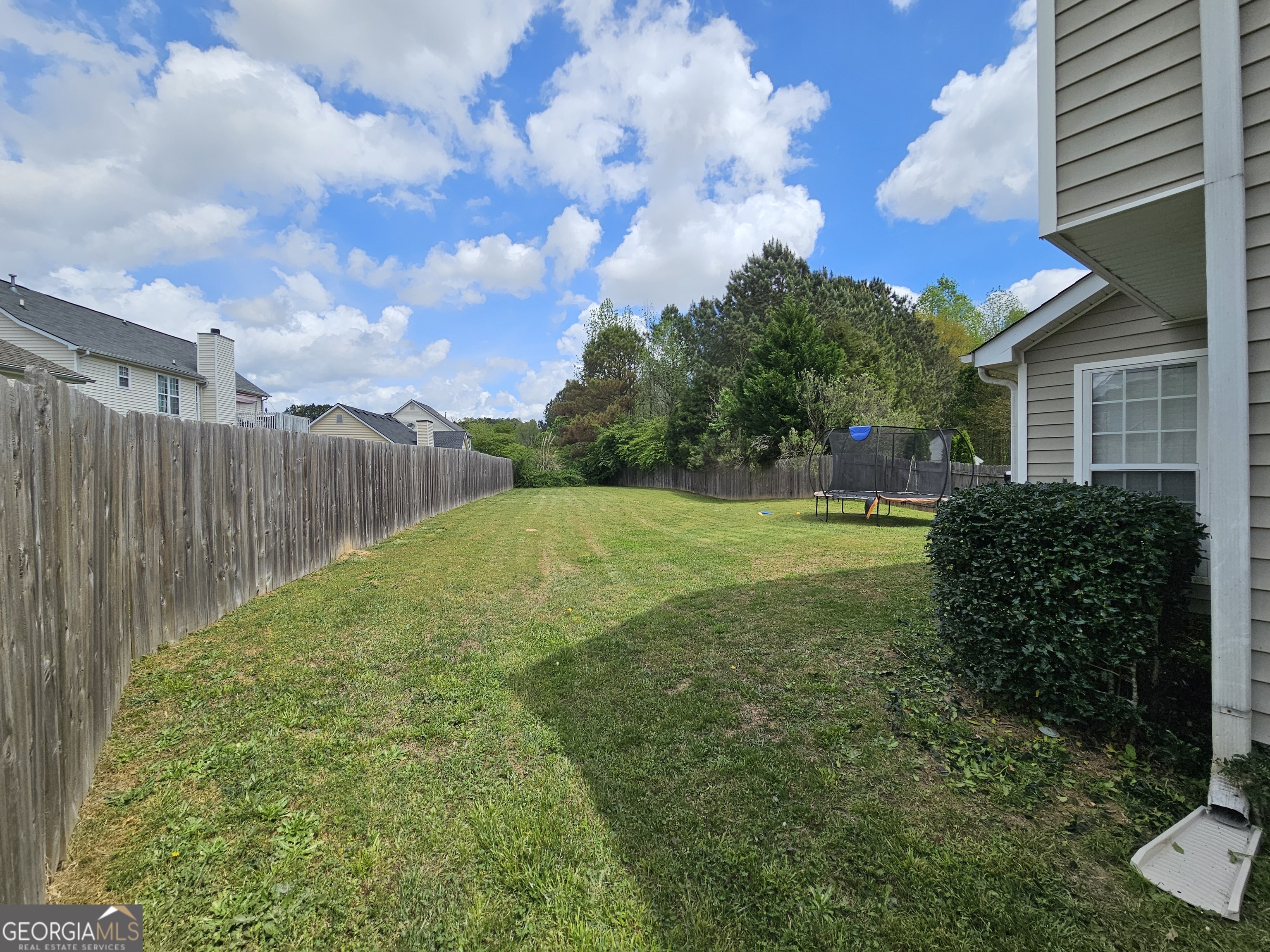 5077 Meadow Trace Fairburn, GA 30213 - Photo 8 of 43 a view of backyard with green space