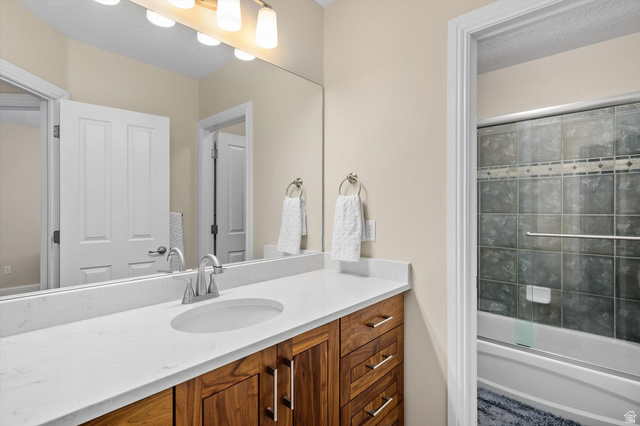 1456 Firelight Way Sandy, UT 84092 - Photo 11 of 22 Bathroom featuring vanity and combined bath / shower with glass door