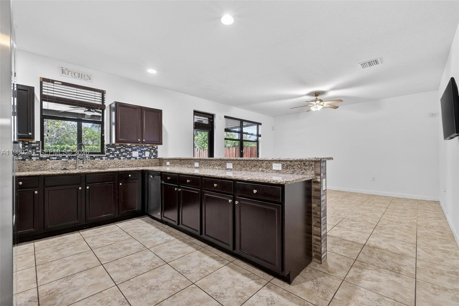 11561 Southwest 232nd Lane Homestead, FL 33032 - Photo 13 of 60 a kitchen with a sink and a stove top oven
