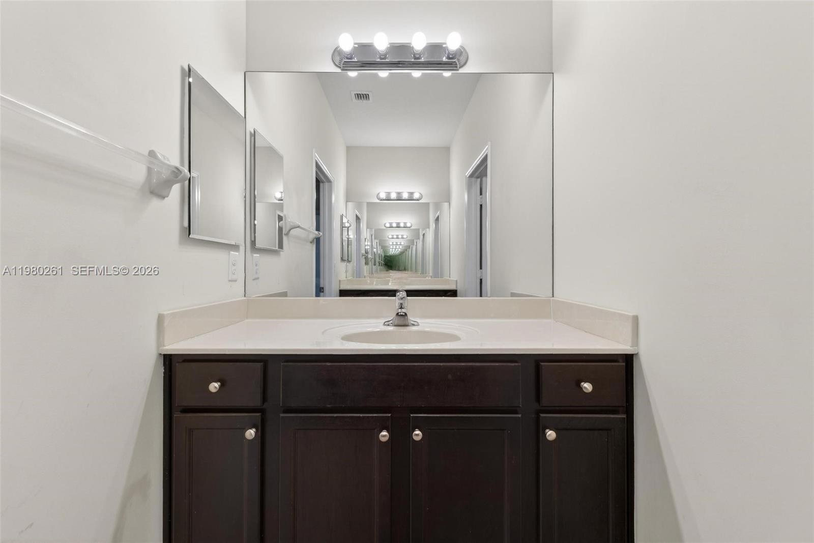 11561 Southwest 232nd Lane Homestead, FL 33032 - Photo 43 of 60 a bathroom with a sink and a mirror