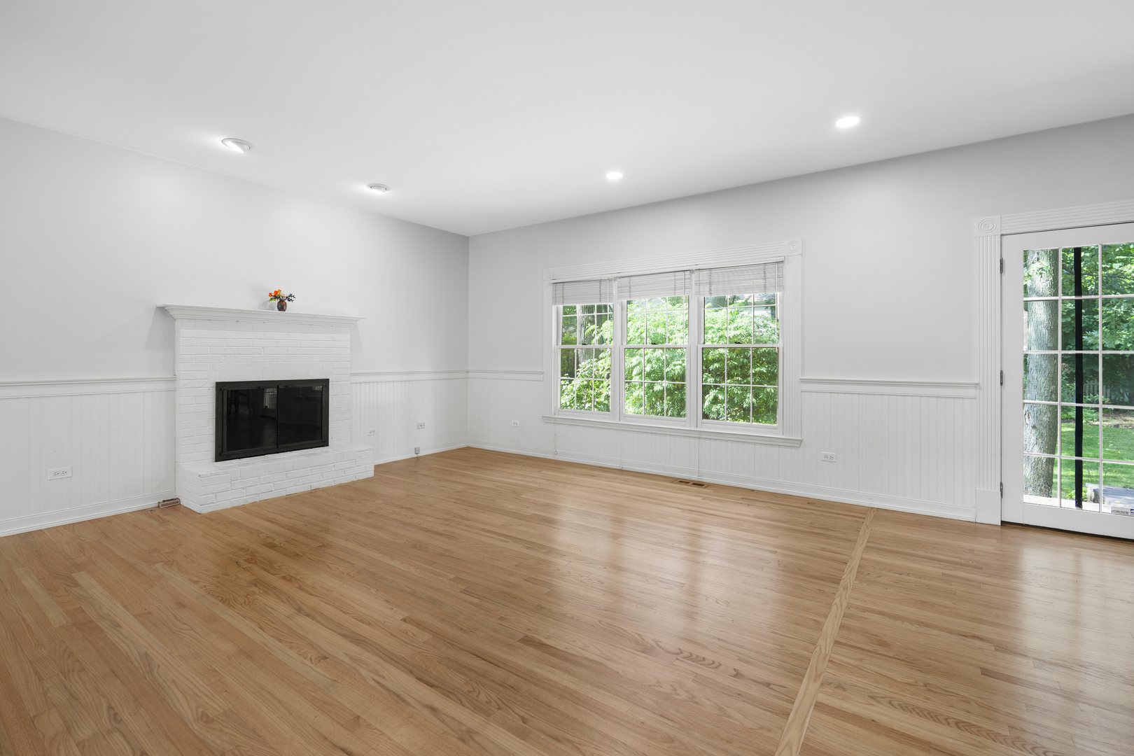 662 Waterbury Avenue Gurnee, IL 60031 - Photo 11 of 51 an empty room with wooden floor and windows
