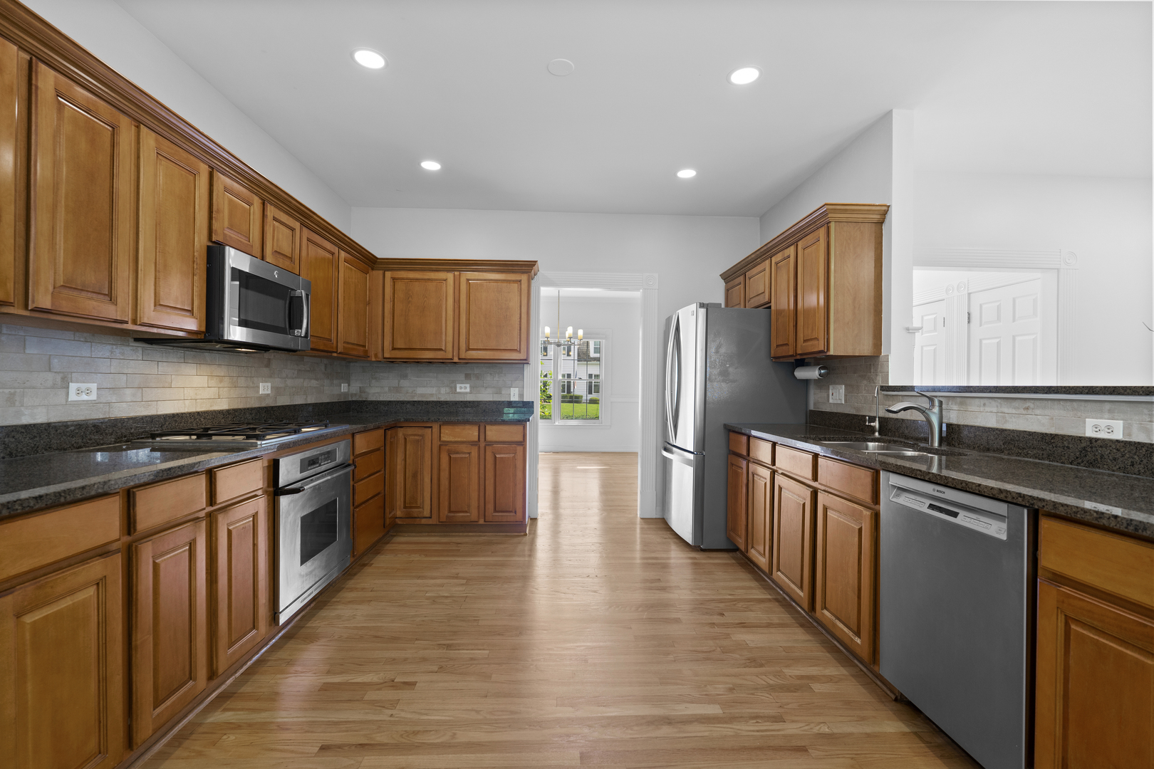 662 Waterbury Avenue Gurnee, IL 60031 - Photo 16 of 51 a kitchen with stainless steel appliances granite countertop wooden cabinets a stove top oven and granite counter tops