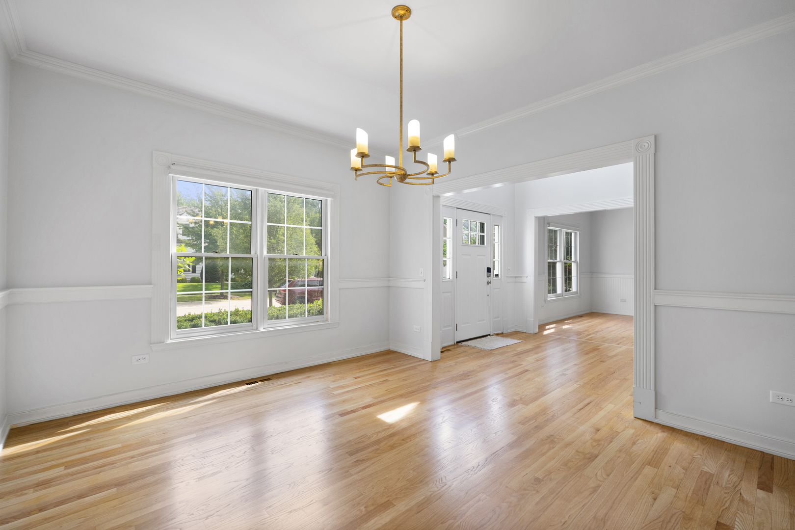 662 Waterbury Avenue Gurnee, IL 60031 - Photo 18 of 51 a view of an empty room with wooden floor and a window