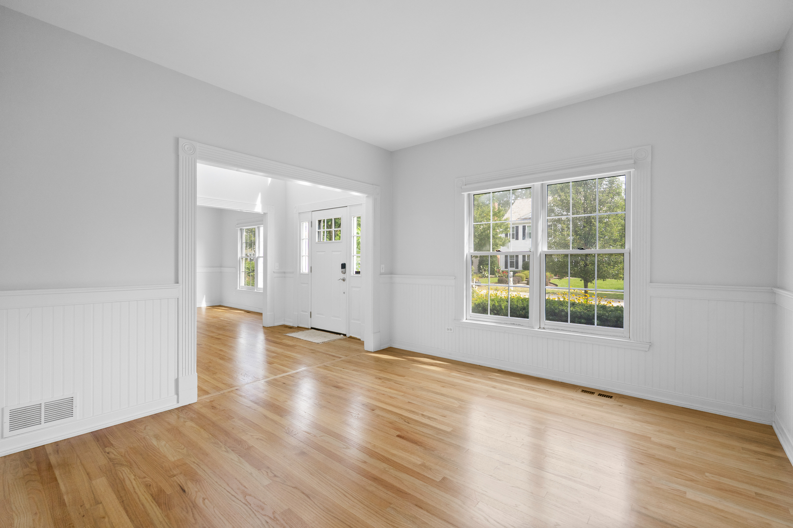 662 Waterbury Avenue Gurnee, IL 60031 - Photo 19 of 51 a view of an empty room with wooden floor and a window