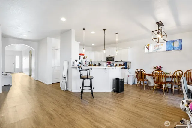 a living room with furniture and kitchen view