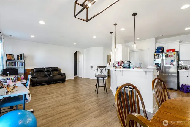 a view of a living room with kitchen and furniture