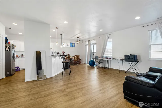 a kitchen with stainless steel appliances white cabinets and wooden floor