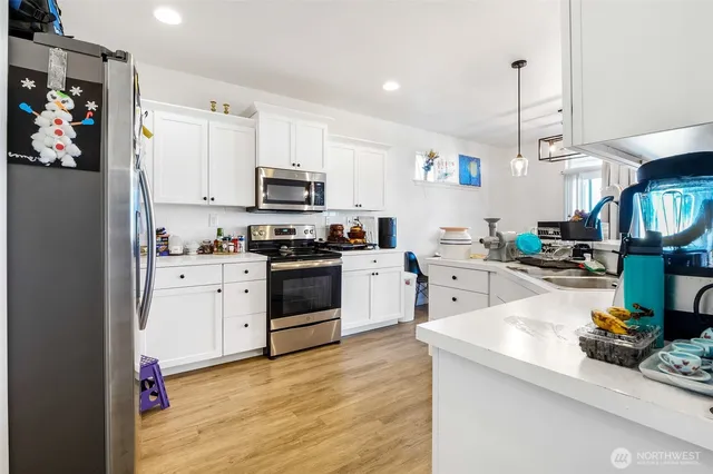 a kitchen with refrigerator and stove