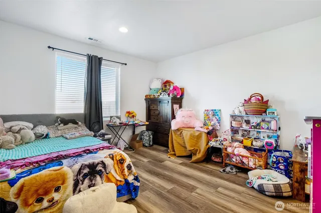 a bedroom with bed and a couch