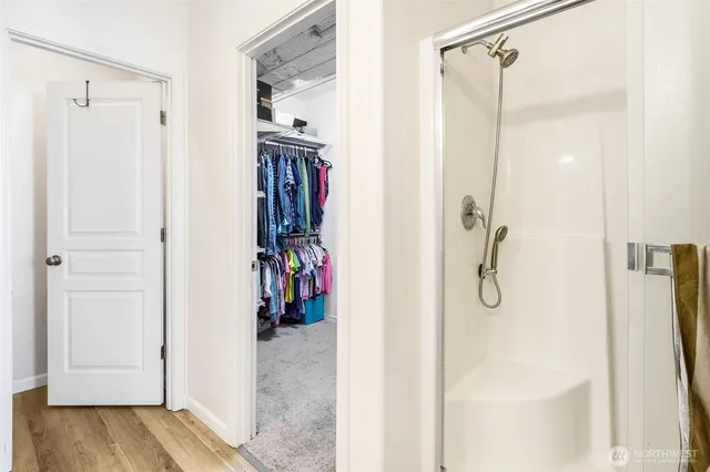 a view of walk in closet with clothes