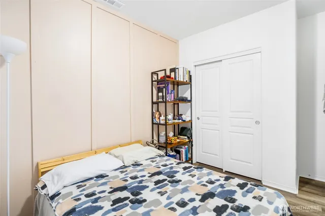 a utility room with dryer washer and a wooden floor