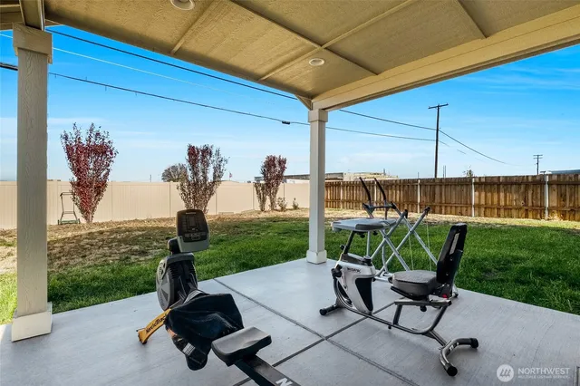 a view of a house with backyard porch and sitting area