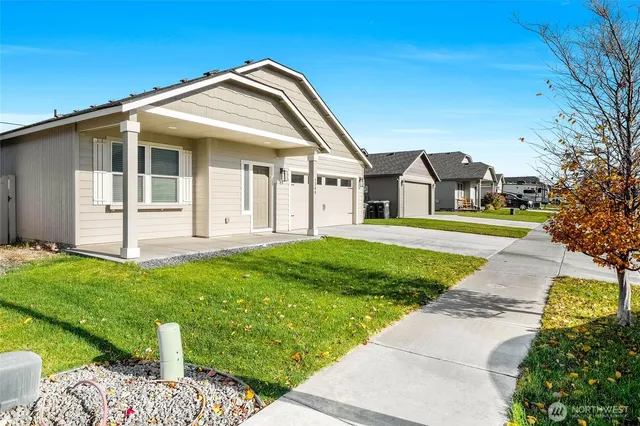 a front view of a house with a garden and yard