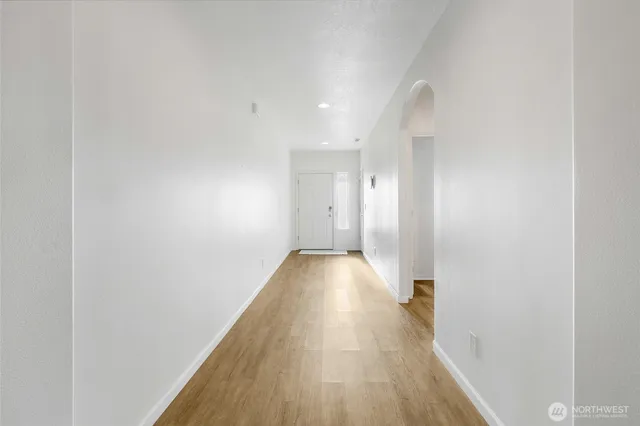 a view of a room with wooden floor and door