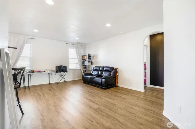 a living room with lots of furniture and kitchen view