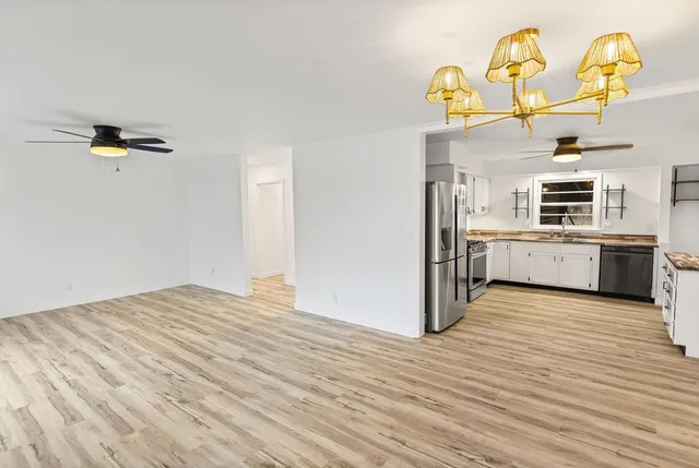 a kitchen with stainless steel appliances granite countertop a stove refrigerator sink and dishwasher