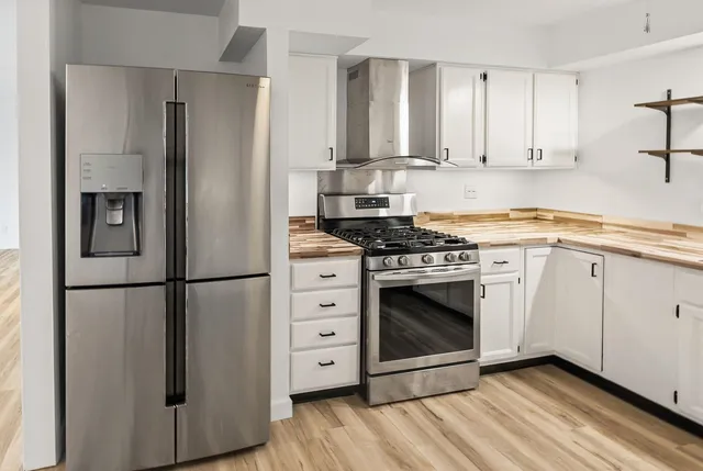 a kitchen with cabinets and appliances