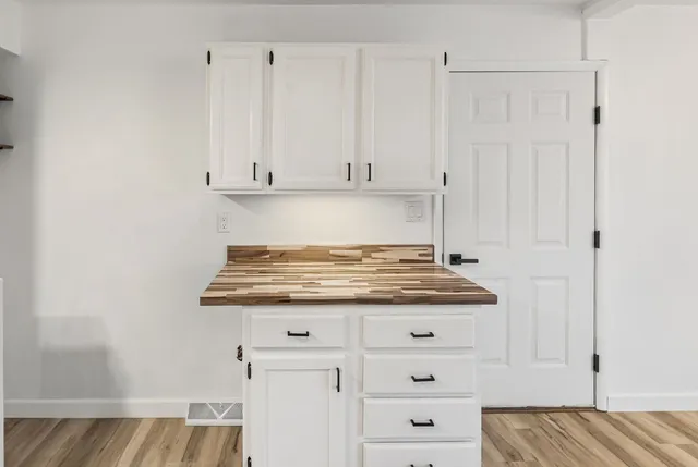 a view of a kitchen with a refrigerator and a stove