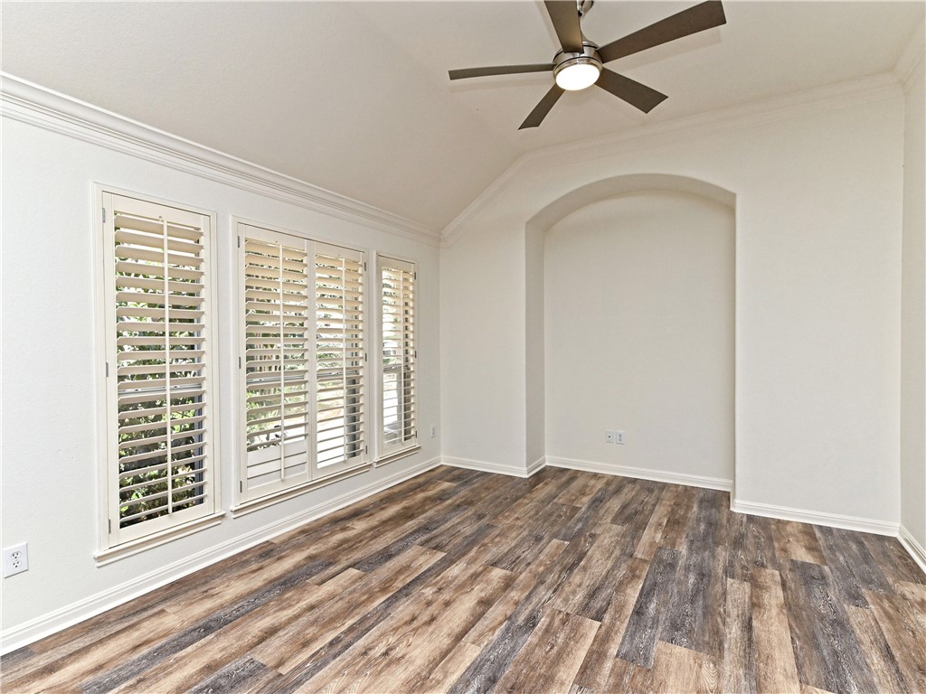 7909 Cobblestone Austin, TX 78735 - Photo 4 of 12 a view of empty room with wooden floor and fan