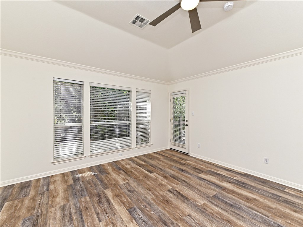 7909 Cobblestone Austin, TX 78735 - Photo 6 of 12 a view of an empty room with wooden floor and a window