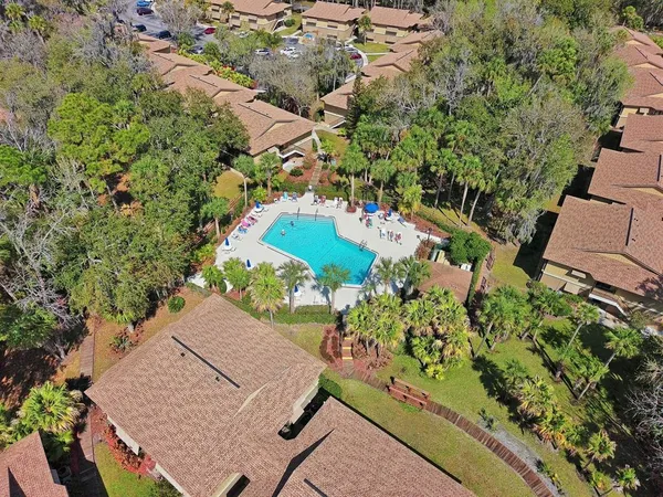 an aerial view of a house with a yard and garden