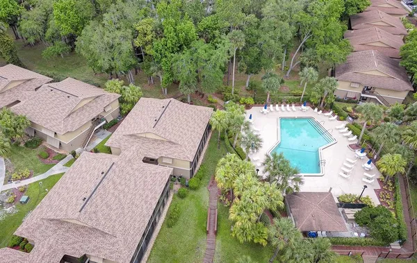 an aerial view of a house with outdoor space and swimming pool