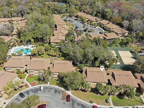 an aerial view of a house with a yard and lake view